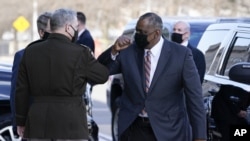 Defense Secretary Lloyd Austin, right, greets Chairman of the Joint Chiefs of Staff Mark Milley as he arrive at the Pentagon, Friday, Jan. 22, 2021, in Washington. (AP Photo/Alex Brandon)