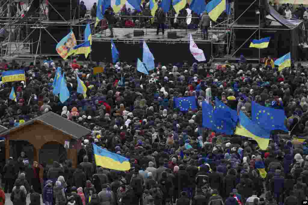 Protestors wave flags during a protest at Independence Square in Kyiv, Dec. 2, 2013.