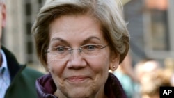 FILE - In this March 5, 2020, file photo, Sen. Elizabeth Warren speaks to the media outside her home in Cambridge, Mass., after she dropped out of the Democratic presidential race.