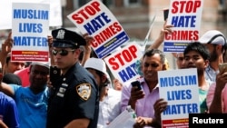 Community members take part in a protest to demand stop hate crime during the funeral service of Imam Maulama Akonjee, and Thara Uddin in the Queens borough of New York City, Aug. 15, 2016. 