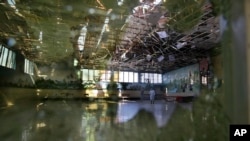 Damage of the Dubai City wedding hall is seen after an explosion in Kabul, Afghanistan, Sunday, Aug. 18, 2019. A suicide-bomb blast ripped through a wedding party on a busy Saturday night. (AP Photo/Rafiq Maqbool)