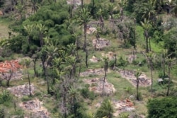 FILE - An aerial view shows burned down villages once inhabited by the Rohingya seen from the Myanmar military helicopters that carried the U.N. envoys to northern Rakhine state, Myanmar, May 1, 2018.