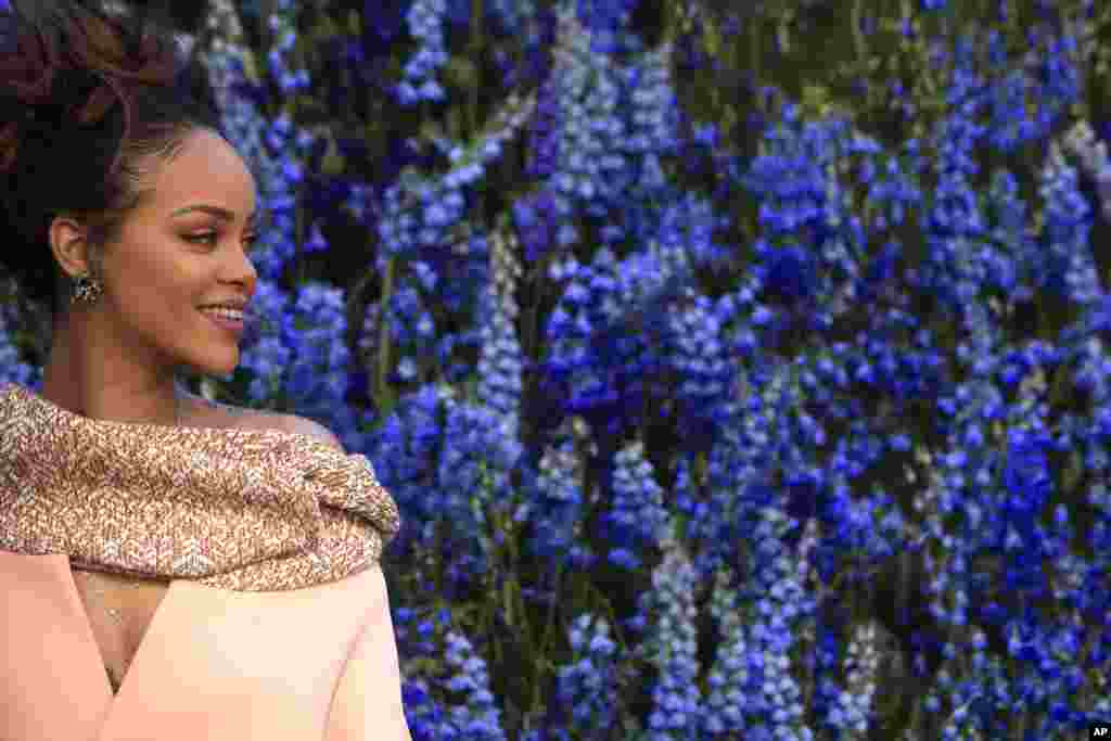 Singer Rihanna smiles as she poses before Christian Dior's Spring-Summer 2016 ready-to-wear fashion collection, presented during Paris Fashion Week, in Paris, France.