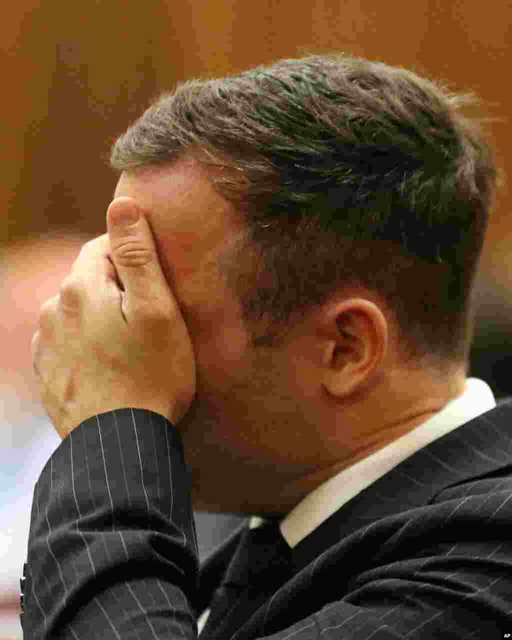 Oscar Pistorius gestures as the sentencing process entered a second day, Pretoria, South Africa, Oct. 14, 2014.