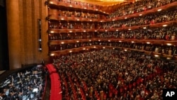 In this photo provided by the Metropolitan Opera, people stand for the national anthem before the performance of Terence Blanchard's "Fire Shut Up in My Bones," on September 27, 2021, in New York City. (Jonathan Tichler/Metropolitan Opera via AP)