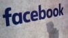 FILE - A Facebook logo is displayed at a start-up companies' gathering in Paris, France, Jan. 17, 2017. 