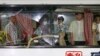 FILE - Alberto Lubang (L), the bus driver who survived the August 23 hostage crisis in which eight Hong Kong tourists were killed in Manila, is joined by members of the inquiry and review committee during an inspection of the bus at Camp Bagong Diwa in Taguig City, Manila, September 8, 2010. 