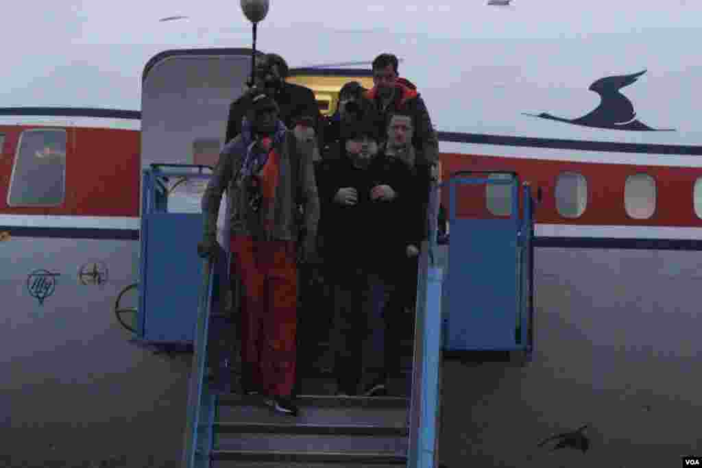 Dennis Rodman disembarks from a flight from Beijing as he and his entourage arrive at the international airport in Pyongyang, Dec. 19, 2013. 