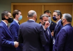 French President Emmanuel Macron speaks with Hungary's Prime Minister Viktor Orban next to Poland's Prime Minister Mateusz Morawiecki, Austria's Chancellor Sebastian Kurz and Greece's Prime Minister Kyriakos Mitsotakis, in Brussels, Dec. 10, 2020.