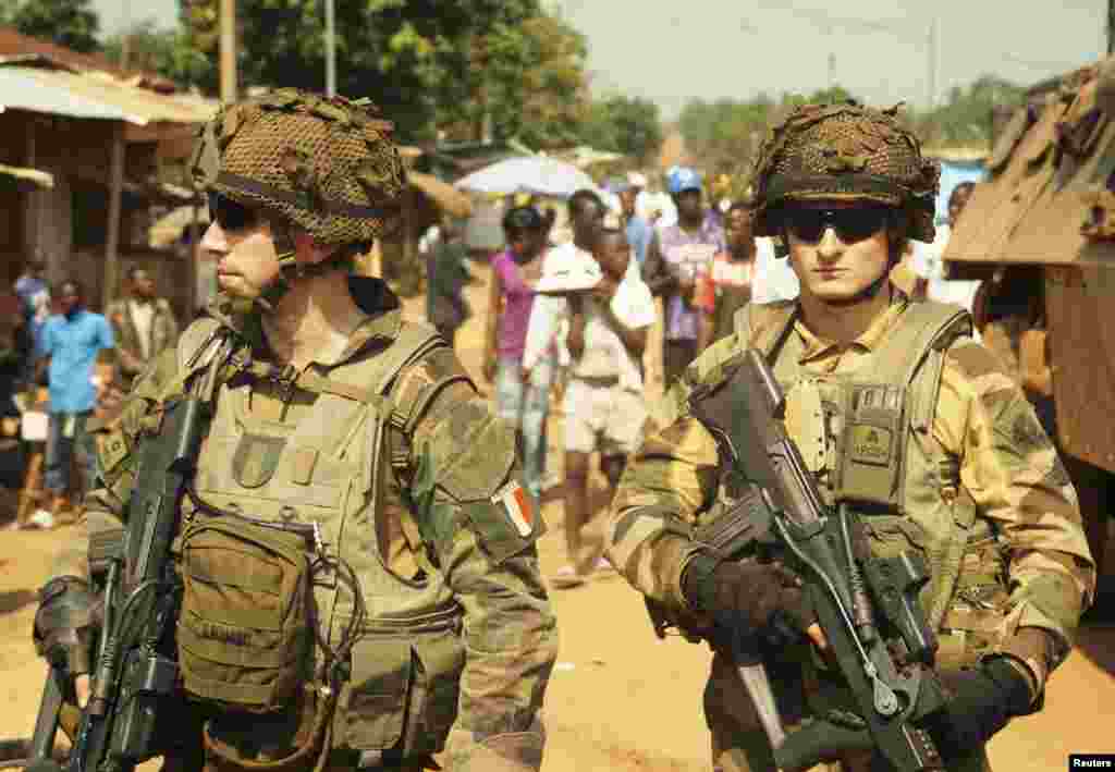 French soldiers carry their weapons as they patrol Boy-Rabe, a northern district of Bangui, Central African Republic, Dec. 17, 2013.