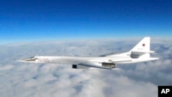 In this image made available by the Royal Air Force, Jan. 15, 2018, a Russian Tu-160 long-range bomber is photographed by an RAF aircraft.