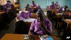 Des élèves de l'Oregun Junior and Senior High School assistent à des conférences dans une salle de classe à Lagos au Nigeria, le lundi 18 janvier 2021. (Photo AP/Sunday Alamba)