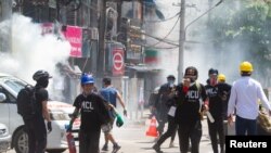 Gas air mata ditembakkan di sekitar para demonstran yang melarikan diri dari polisi dalam unjuk rasa antikudeta di Yangon, Myanmar, 8 Maret 2021. (Foto: Reuters)