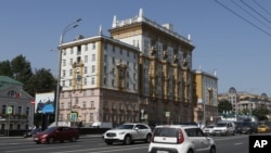 FILE - Vehicles drive past the U.S. Embassy in Moscow, Aug. 21, 2017. 