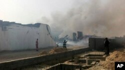 Smoke rises over the rubble of buildings damaged in explosions that took place at midnight, Salaheddin district, Tripoli, Libya, May 21, 2014.