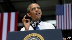 President Barack Obama gestures as he speaks at the Amazon fulfillment center in Chattanooga, Tennessee, July 30, 2013.