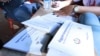 Cambodian health workers give away information on HIV prevention to residents in Peam village, Kandal province, Cambodia, Monday, February 22, 2016. (Photo: Aun Chhengpor/VOA Khmer)