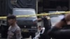 Members of a police forensic team inspect the site of a bombing at the local police headquarters in Medan, North Sumatra, Indonesia, Nov. 13, 2019.
