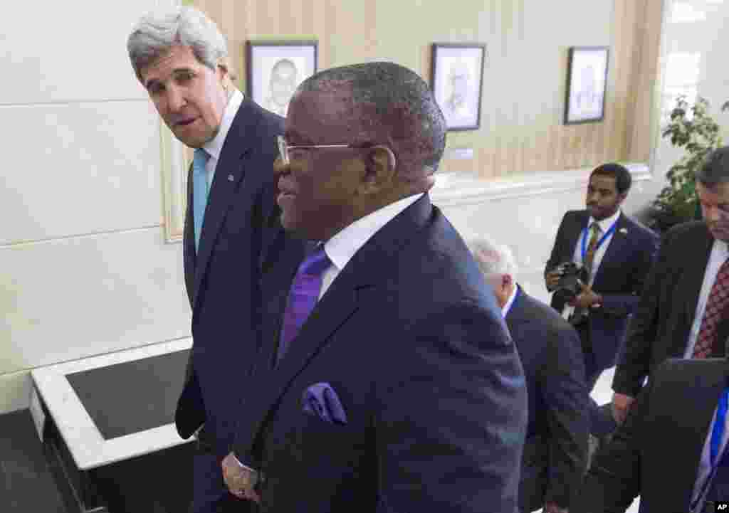 Angola's Foreign Minister Georges Rebelo Chicoti, right, walks with U.S. Secretary of State John Kerry prior to their meeting at the Finance Ministry in Luanda, Angola, May 5, 2014.