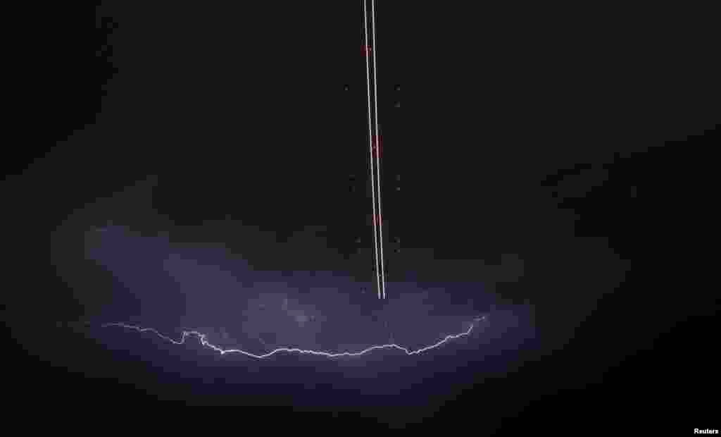 A jet aircraft takes off as lightning strikes across the sky during a monsoon storm at McCarran International Airport in Las Vegas, Nevada, USA, July 7, 2014.