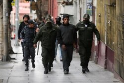 Members of the security forces detain demonstrators during clashes with supporters of former Bolivian President Evo Morales, in Murillo square, in La Paz, Bolivia, Nov. 13, 2019.