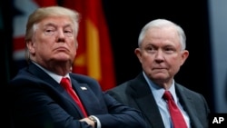 FILE - President Donald Trump sits with Attorney General Jeff Sessions during the FBI National Academy graduation ceremony in Quantico, Va., Dec. 15, 2017. 