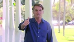 Brazil's President Jair Bolsonaro gestures as he speaks to the media on his positive coronavirus diagnosis in Brasilia, Brazil, July 7, 2020.