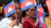 Garment workers welcome Prime Minister Hun Sen outside of Phnom Penh, Cambodia, Wednesday, Aug. 30, 2017. Hun Sen is on a country-wide trip to visit the nation's factory workers to hear their hopes and concerns in person. (AP Photo/Heng Sinith)