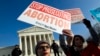 FILE - Abortion rights activists protest outside of the U.S. Supreme Court, during the March for Life in Washington, Jan. 18, 2019. 