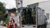 FILE - Vietnamese soldiers look out from a truck as they deliver food in strict lockdown areas amid the COVID-19 pandemic in Ho Chi Minh, Vietnam, August 24, 2021. 