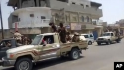 In this frame grab from video provided by Yemen Today, Yemeni army vehicles enter Zinjibar, Yemen, Aug. 28, 2019. 