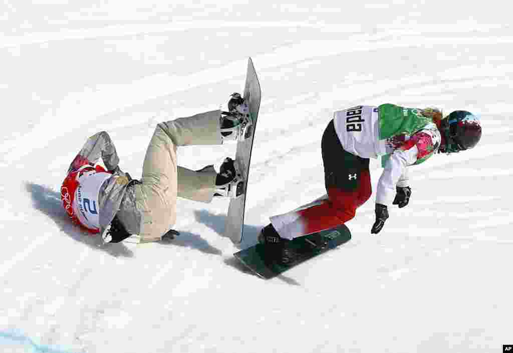 Lindsey Jacobellis of the United States crashes in the women's snowboard semifinal as Canada's Dominique Maltais tries to avoid her at the Rosa Khutor Extreme Park, Krasnaya Polyana, Russia, Feb. 16, 2014.