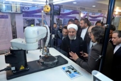 FILE - President Hassan Rouhani listens to explanations of nuclear achievements in Tehran, April 9, 2018.