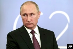 Russian President Vladimir Putin speaks to the media after the G-20 summit in Buenos Aires, Argentina, Dec. 1, 2018. Putin and Trump "said hi to each other," according to the Russian leader's spokesman, but didn't shake hands or otherwise speak.