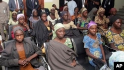 In this photo released by the Nigeria State House, Chibok schoolgirls recently freed from Boko Haram captivity are seen during a meeting with Nigeria's Vice President Yemi Osinbajo, in Abuja, Nigeria, Oct. 13, 2016.