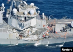 The Arleigh Burke-class guided-missile destroyer USS Fitzgerald, damaged by colliding with a Philippine-flagged merchant vessel, is seen off Shimoda, Japan, June 17, 2017, in this photo taken by Kyodo.