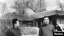 The late North Korean leader Kim Jong-il (L) and his father, the late North Korean founder Kim Il-sung, are seen in this undated photo released by state media.
