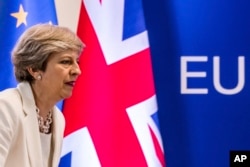FILE - British Prime Minister Theresa May prepares to address a press conference at an EU summit in Brussels, Belgium, June 23, 2017.