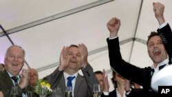 Germany Election: AfD member Alexander Gauland, left, and Leif-Erik Holm, center, top candidate of the AfD, celebrate at the gathering of the AfD (Alternative for Germany) party in Schwerin, Germany, Sunday, Sept. 4, 2016 after the state elections in the