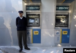 A pensioner waits outside a branch of the National Bank of Greece hoping to get his pension, in Thessaloniki, Greece, June 29, 2015.