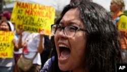 A protester shouts during a rally outside the offices of the Metropolitan Waterworks and Sewerage System and Manila Water Company in Quezon city, metropolitan Manila, Philippines to demand better water supply, March 15, 2019.