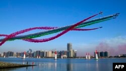 The United Arab Emirates' Al-Fursan (The Knights) National Aerobatic Team performs with smoke with the colours of the UAE flag, during the 2018 Red Bull Air Race World Championship in the Emirati capital Abu Dhabi on February 3, 2018. 