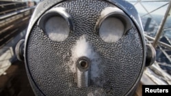A coin-operated binoculars' eye holes are full of snow on the roof of Empire State Building in the Manhattan borough of New York, Feb. 14, 2014.