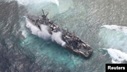 FILE - The USS Guardian, a U.S. Navy minesweeper, is seen at the Vicinity of South Islet in Tubbataha Reefs after it ran aground in Palawan province, west of Manila January 19, 2013 in this handout picture distributed by the Armed Forces of the Philippine