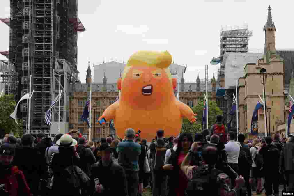 A "Baby Trump" balloon is seen over demonstrators as they participate in an anti-Trump protest in London.