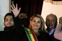 Bolivian Senator Jeanine Anez gestures after she declared herself as interim President of Bolivia, at the balcony of the Presidential Palace, in La Paz, Bolivia, Nov. 12, 2019.