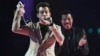 Mark Ronson celebrates with Lionel Richie after receiving the British Single award at the BRIT music awards at the O2 Arena in Greenwich, London, Feb. 25, 2015. 