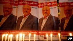 FILE - Candles, lit by activists protesting the killing of Saudi journalist Jamal Khashoggi, are placed outside Saudi Arabia's consulate in Istanbul, Oct. 25, 2018. 