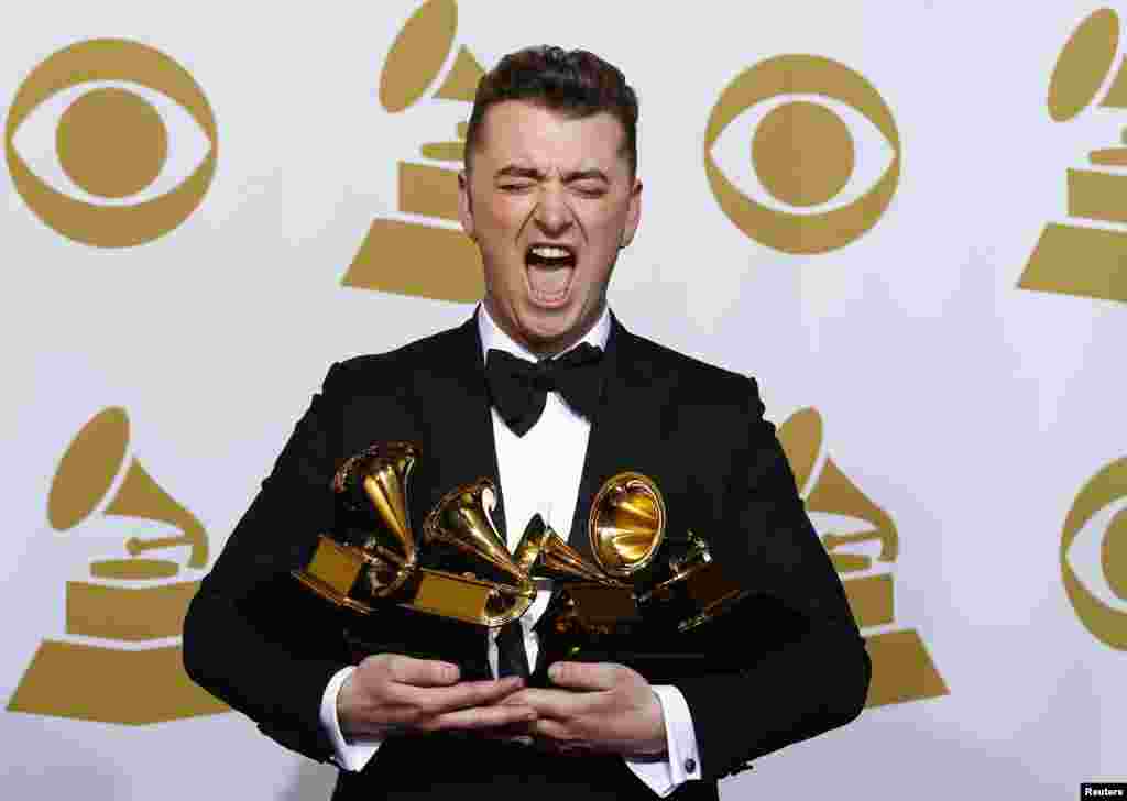 Sam Smith poses with his awards for Best New Artist, Best Pop/Vocal Album for "In the Lonely Hour" and Song of the Year and Record of the Year for "Stay With Me" in the press room at the 57th annual Grammy Awards in Los Angeles, California, Feb. 8, 2015.