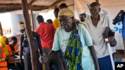 Kassa Wani and her husband, Alfred, from South Sudan, wait to register with U.N. officials as they arrive at the Busia, South Sudan processing center, March 29, 2017